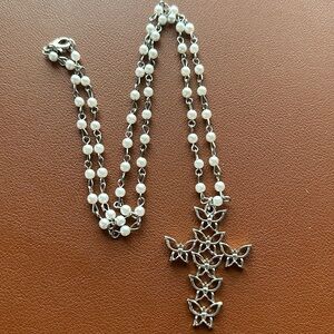 Silver and white cross necklace 24” ‎ in length. Cross is made of butterflies.